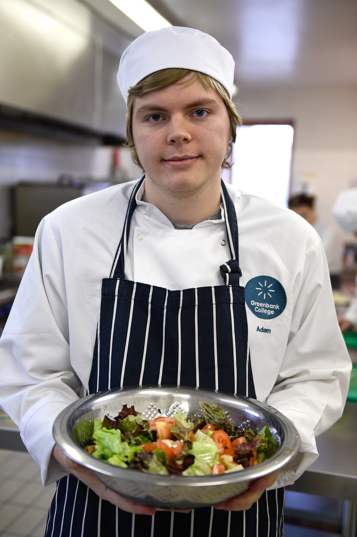 Catering student Adam with a prepared salad